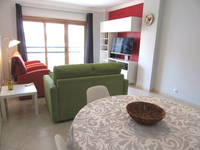Good size living room with dining area and access to a balcony