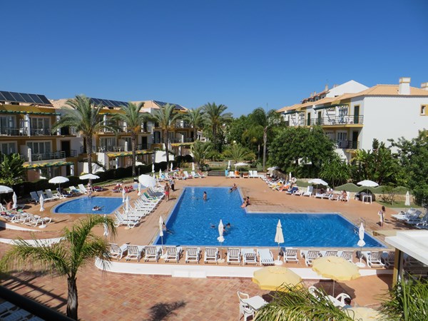 Quinta do Morgado - Monte da Eira, view from the top floor apartment towards the large swimming pools for adults, children and todlers with large lawn areas and sunterraces with sunloungers and pool bar